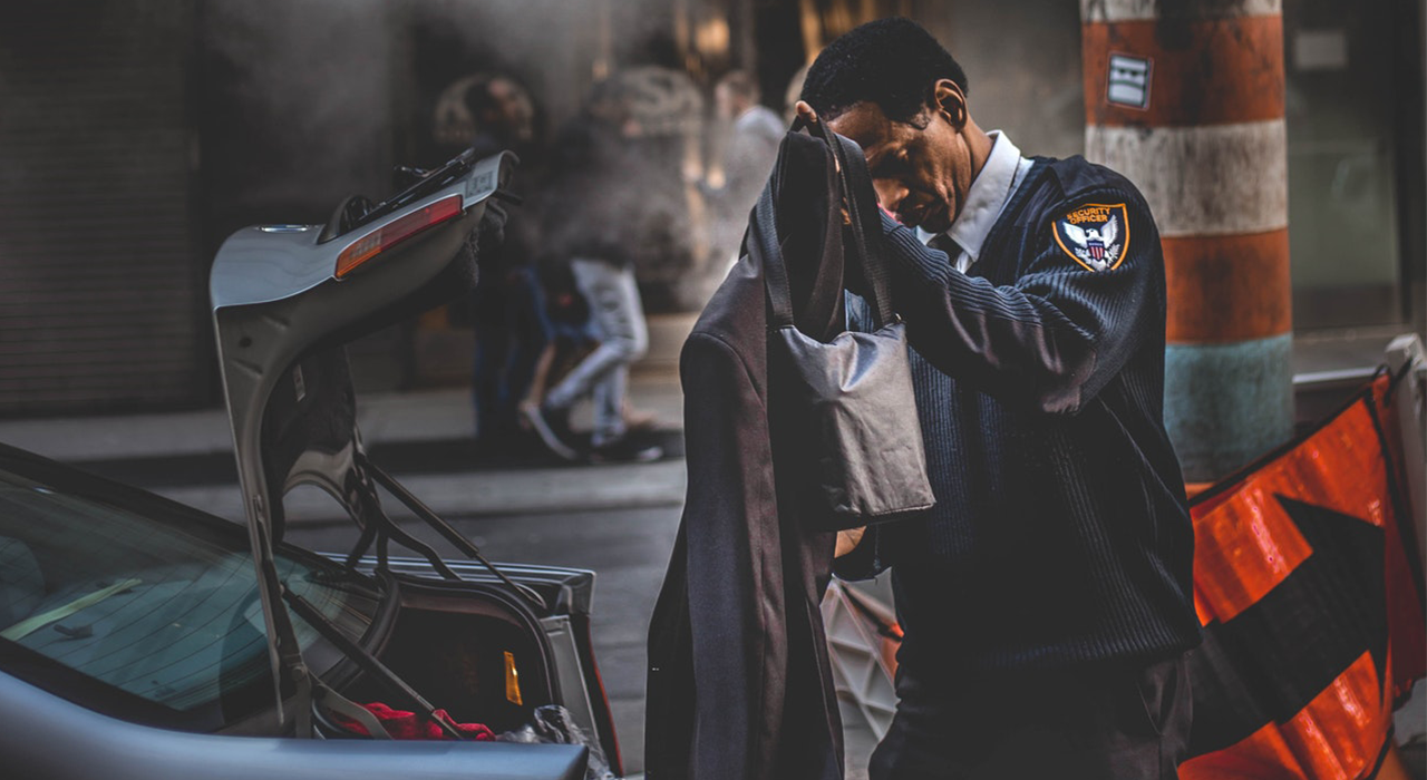 Security Guard getting his jacket out of a car